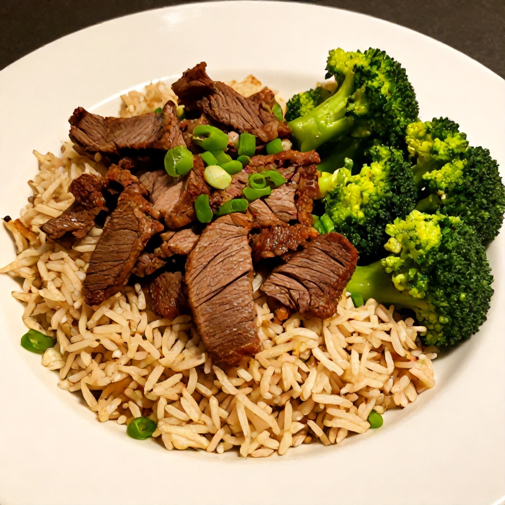 One perfect plated serving of Beef and Broccoli Rice Bowls on a white plate, garnished with green onions, with warm side lighting highlighting the crispy beef and tender broccoli.
