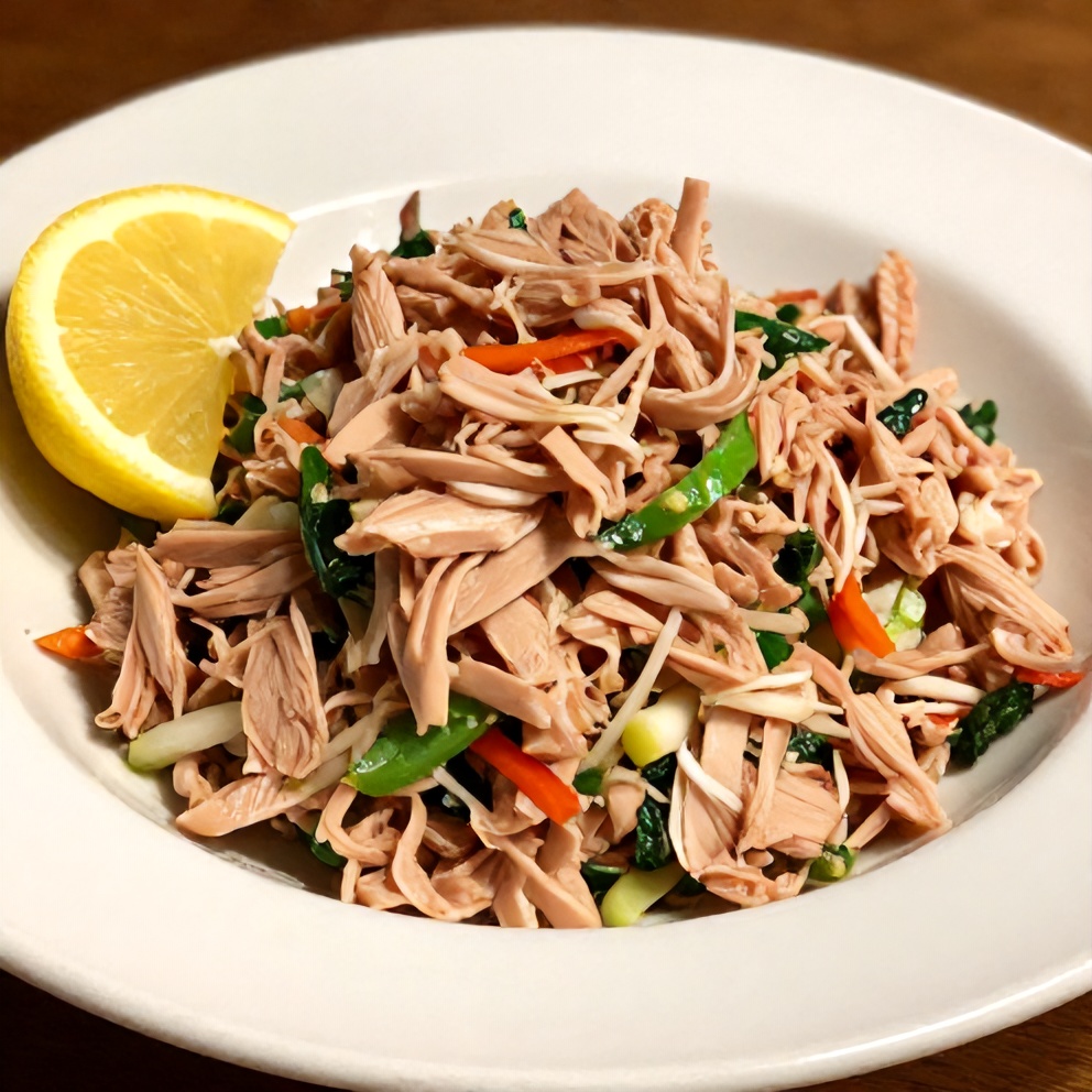 Mediterranean Tuna Salad plated on a white dish with a lemon wedge