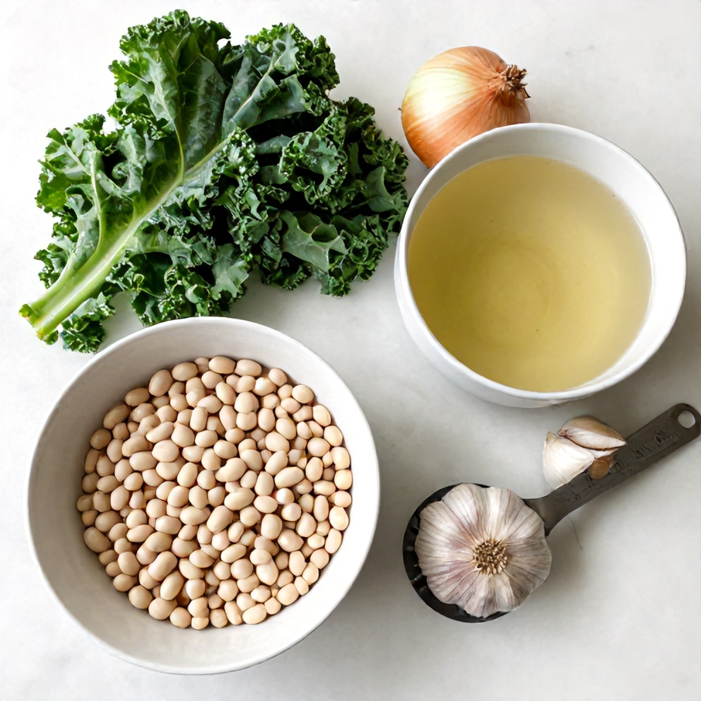 White beans, kale, onion, garlic, and vegetable broth arranged on a white marble surface