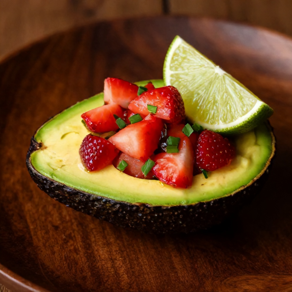 Plated Fresh Strawberry Salsa Stuffed Avocados with a lime wedge