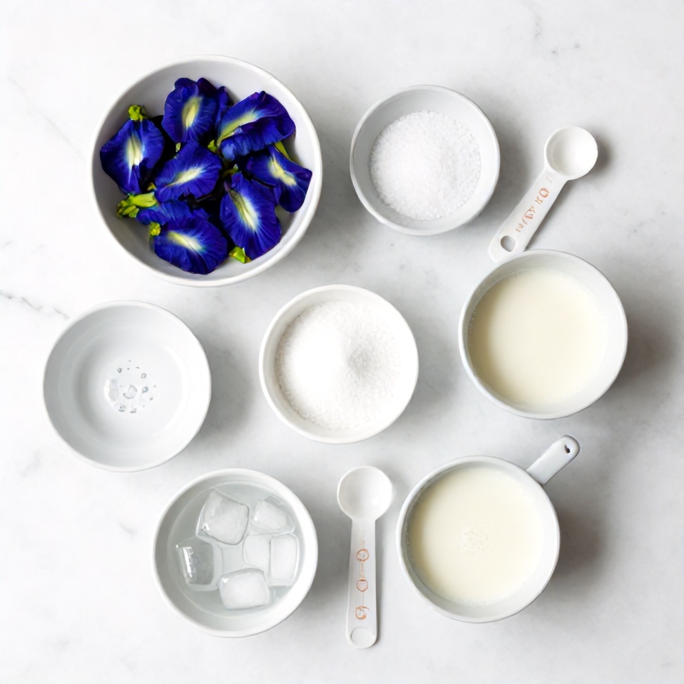 Raw ingredients for iced butterfly pea flower tea latte: butterfly pea flowers, water, sugar, milk, ice